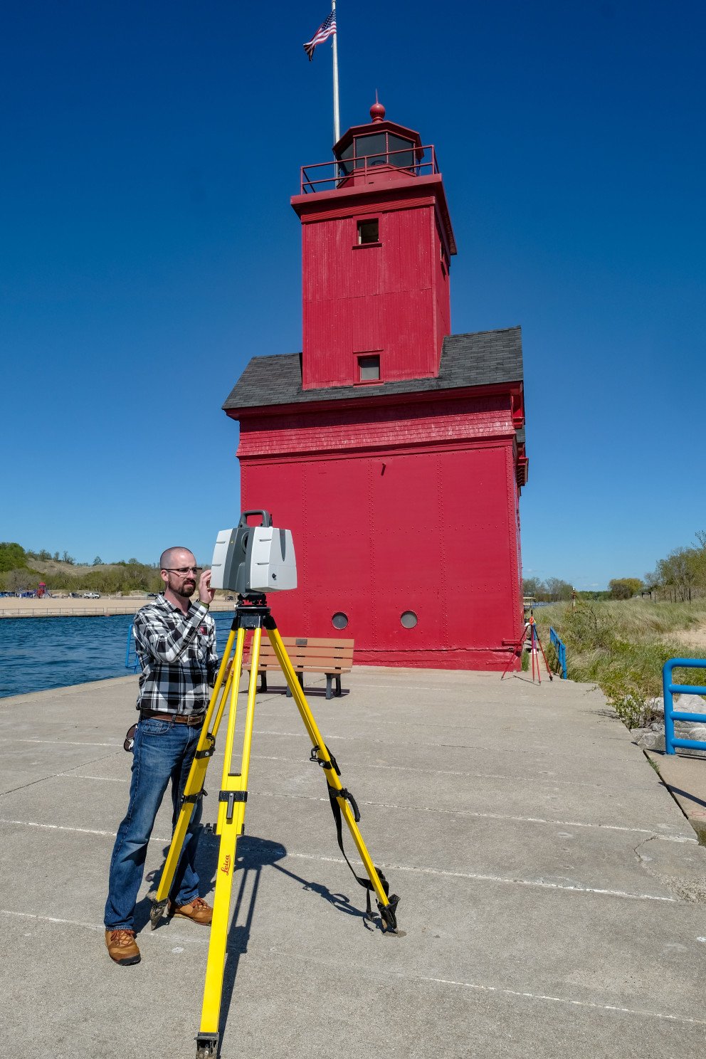 Holland Lighthouse exterior view with Wightman employee and scanner in foreground vertical view